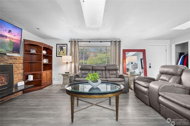 living room featuring hardwood / wood-style flooring and a skylight