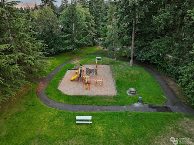 surrounding community with a yard and a playground