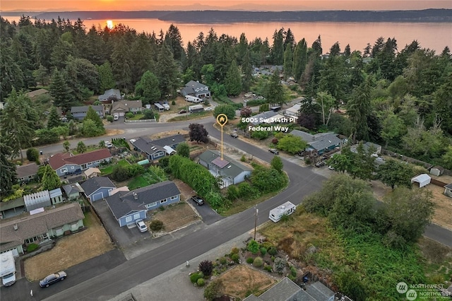 aerial view at dusk with a water view