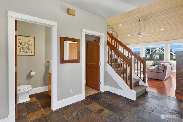 staircase featuring wood ceiling and ceiling fan