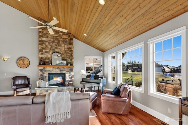 living room with a healthy amount of sunlight, wood ceiling, a fireplace, and light hardwood / wood-style flooring