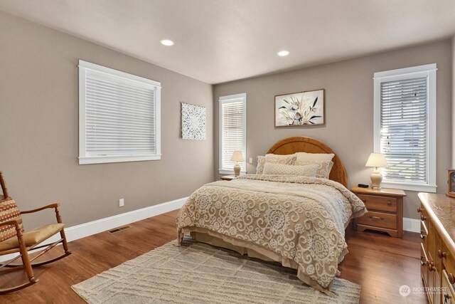 bedroom with hardwood / wood-style flooring