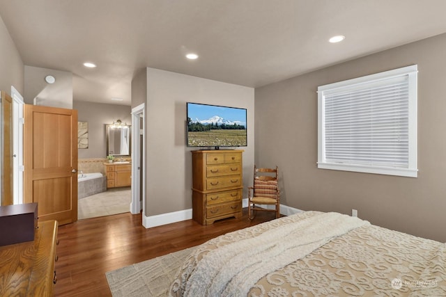 bedroom with ensuite bath and wood-type flooring