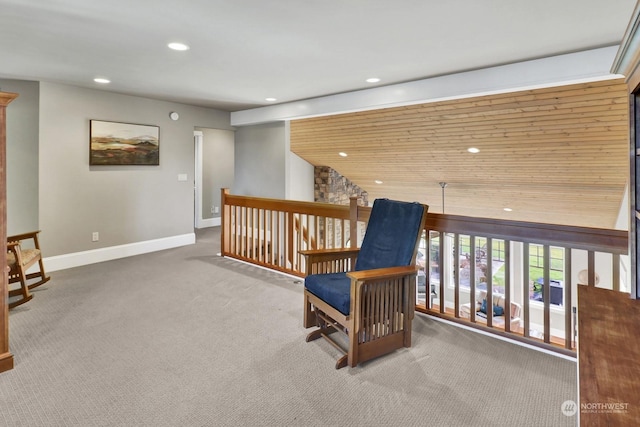 living area featuring wood ceiling and carpet floors