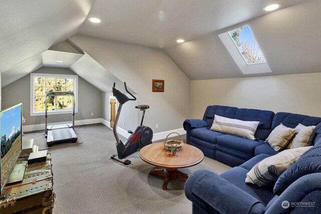 exercise room featuring vaulted ceiling with skylight and carpet