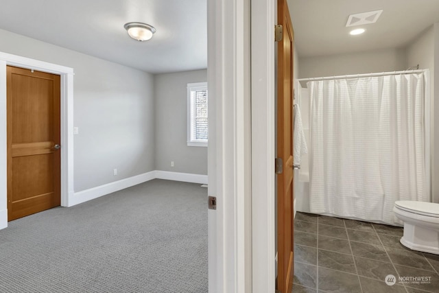 bathroom with shower / tub combo with curtain and toilet