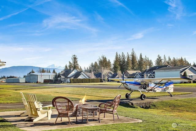 exterior space with a mountain view and an outdoor fire pit