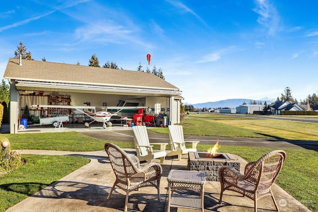 view of patio with a mountain view and a fire pit