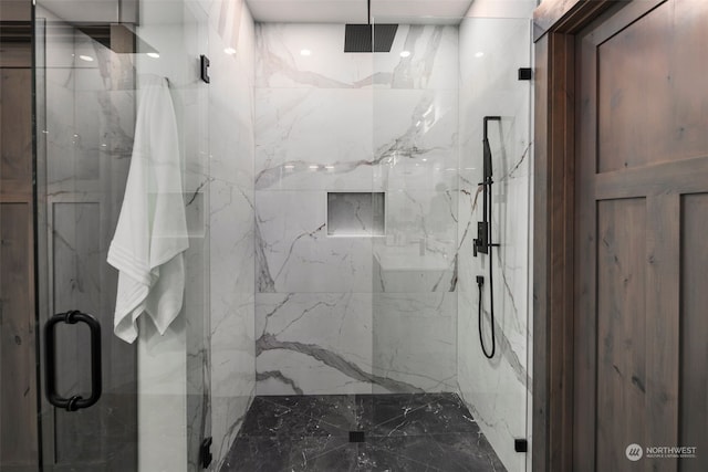 bathroom featuring a shower with shower door