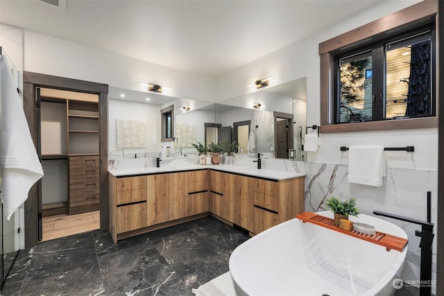 bathroom featuring a bathing tub and vanity