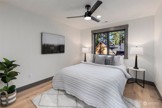 bedroom featuring light hardwood / wood-style floors and ceiling fan