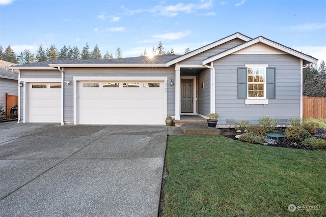 view of front of house with a garage and a front lawn