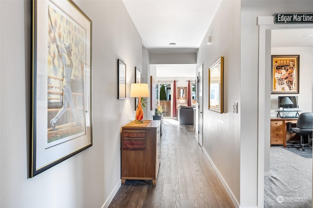 corridor with dark hardwood / wood-style flooring