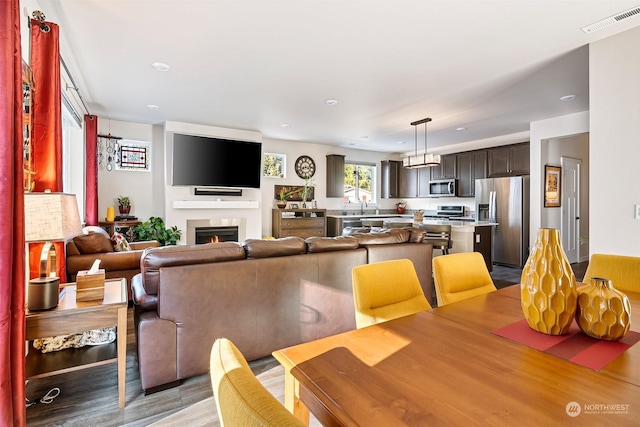 dining area featuring sink and light wood-type flooring