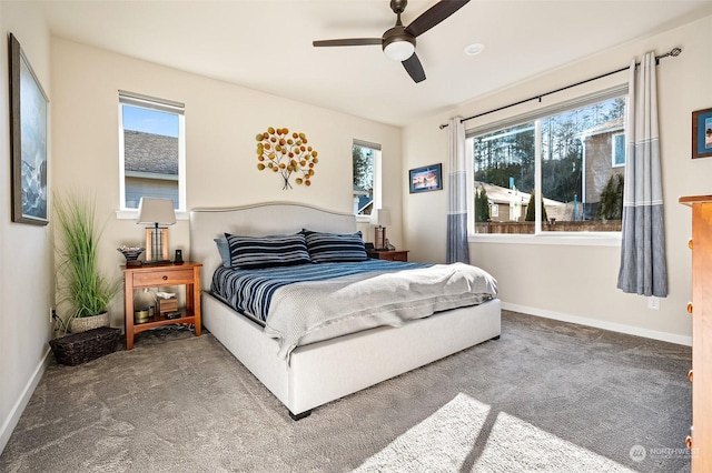 carpeted bedroom with multiple windows and ceiling fan