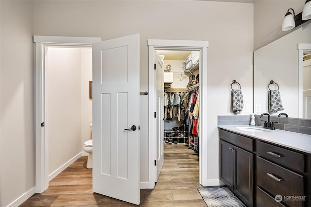 bathroom featuring vanity, toilet, and hardwood / wood-style floors