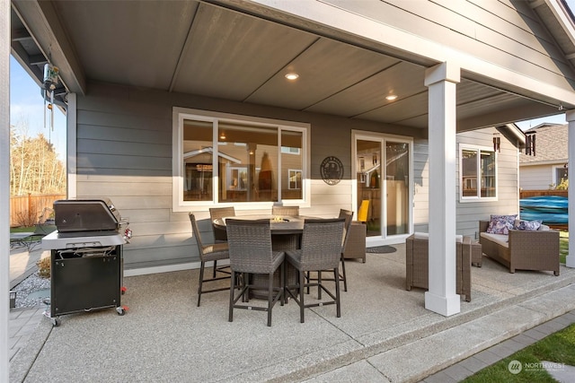 view of patio / terrace with a grill and an outdoor living space with a fire pit