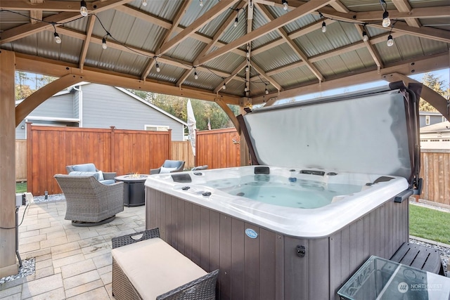 view of patio / terrace with a gazebo, a hot tub, and outdoor lounge area