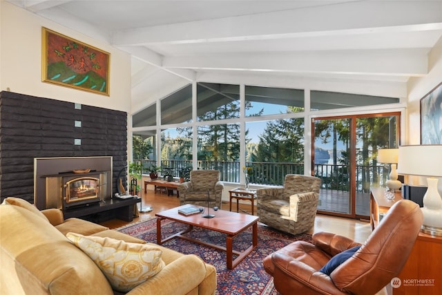 living room featuring lofted ceiling with beams, hardwood / wood-style floors, and a wealth of natural light