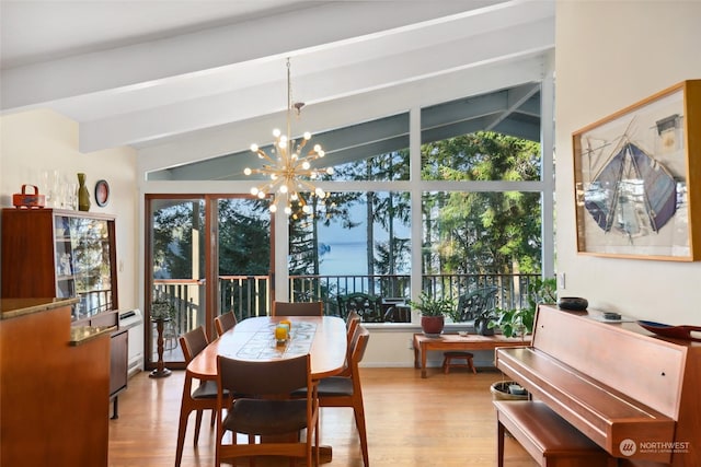 dining space featuring a notable chandelier, lofted ceiling with beams, and light wood-type flooring