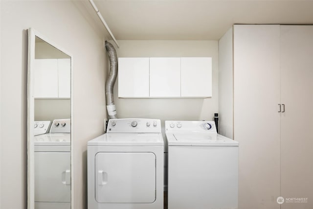 laundry area with cabinets and independent washer and dryer