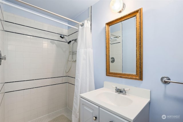 bathroom featuring walk in shower and vanity