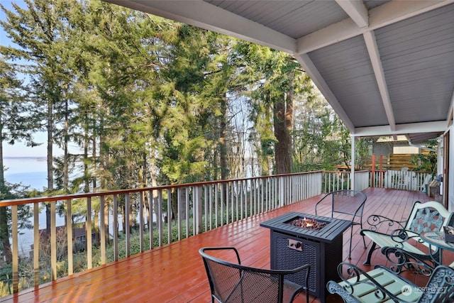 wooden deck with a fire pit