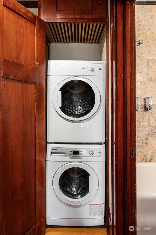 washroom featuring stacked washer / dryer