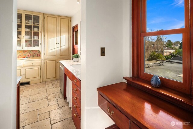 interior space featuring cream cabinets and stainless steel dishwasher