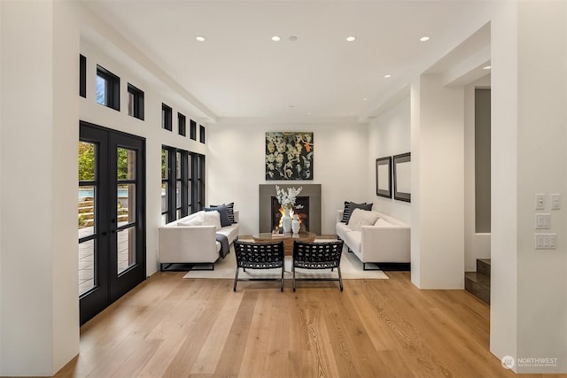 living area featuring french doors and light hardwood / wood-style flooring