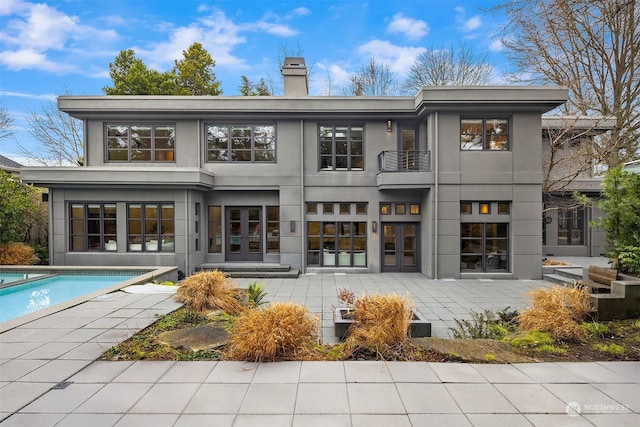 rear view of house with french doors and a patio