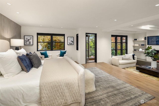 bedroom with light hardwood / wood-style flooring and access to outside