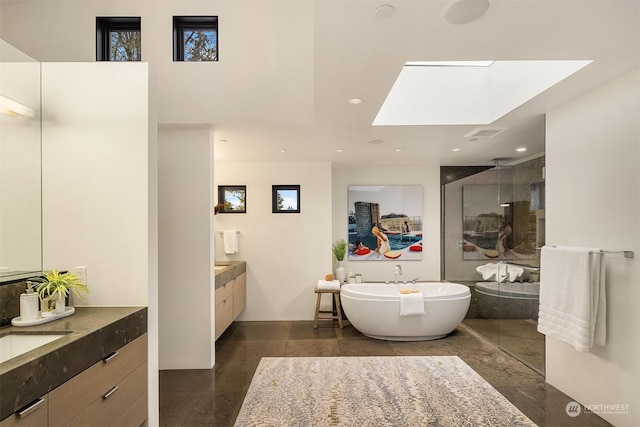 bathroom featuring vanity, separate shower and tub, and a skylight