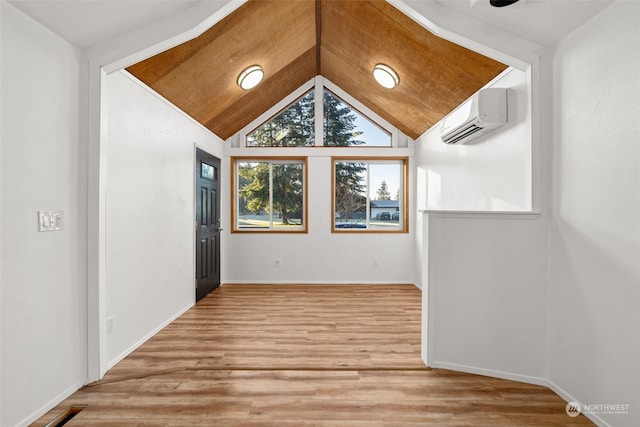 interior space featuring vaulted ceiling, a wall mounted air conditioner, and hardwood / wood-style floors