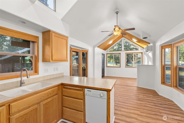 kitchen featuring a healthy amount of sunlight, sink, white dishwasher, and kitchen peninsula