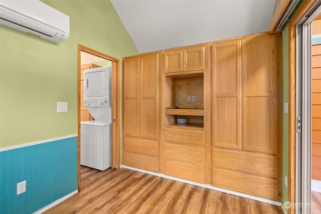 closet with a wall unit AC and stacked washing maching and dryer