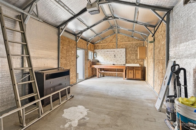 miscellaneous room with lofted ceiling and a workshop area