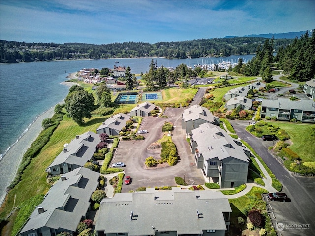 aerial view with a water view, a forest view, and a residential view