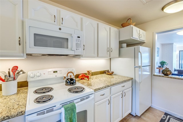 kitchen featuring light tile patterned floors, white appliances, and white cabinetry