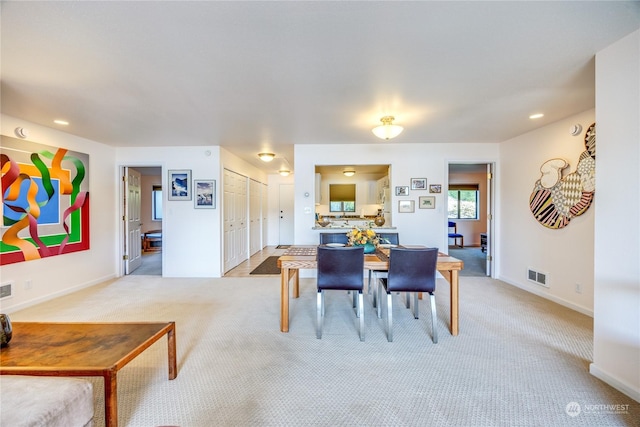 dining area featuring baseboards, recessed lighting, visible vents, and light colored carpet