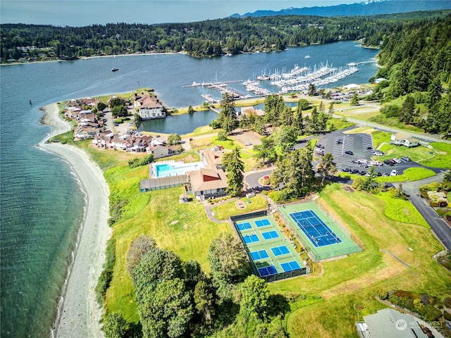 birds eye view of property featuring a water view and a view of trees