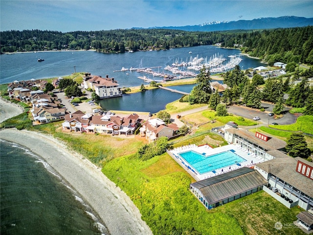 bird's eye view with a water view and a view of trees