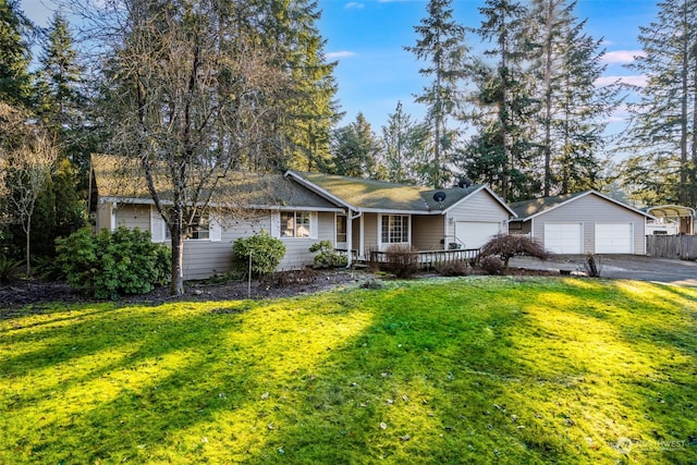 ranch-style home with a garage and a yard