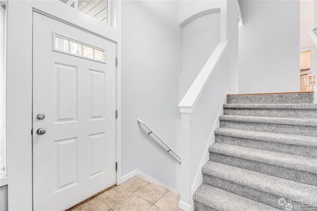 stairs featuring tile patterned floors