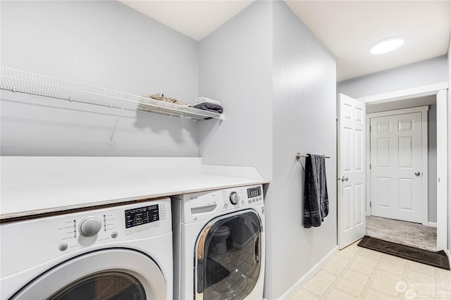 clothes washing area featuring washer and clothes dryer