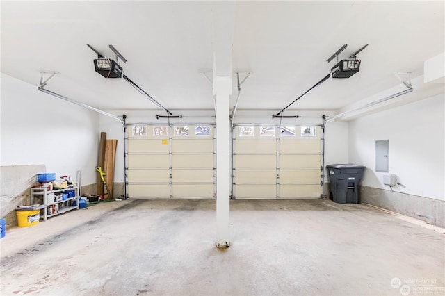 garage featuring a garage door opener and electric panel