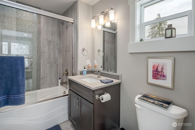 full bathroom with shower / bath combination with glass door, vanity, and toilet