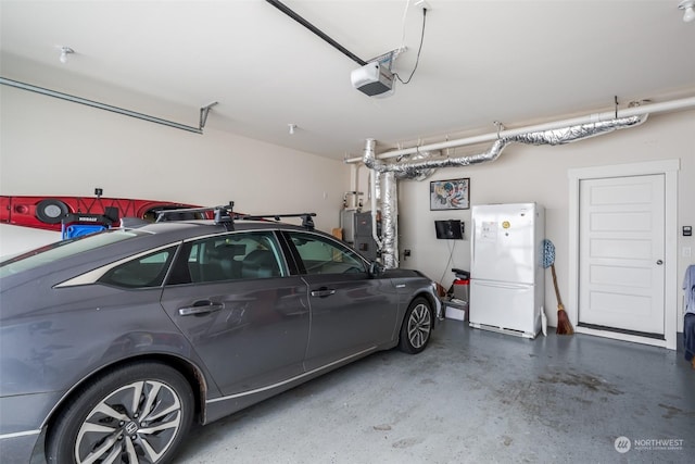 garage with white refrigerator and a garage door opener