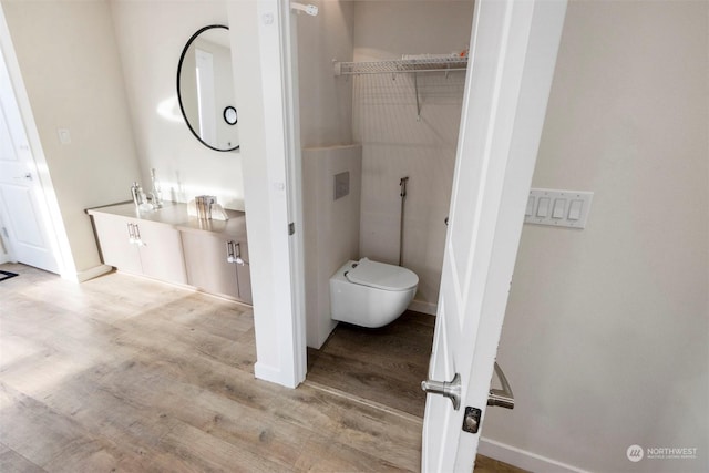 bathroom with wood-type flooring and toilet