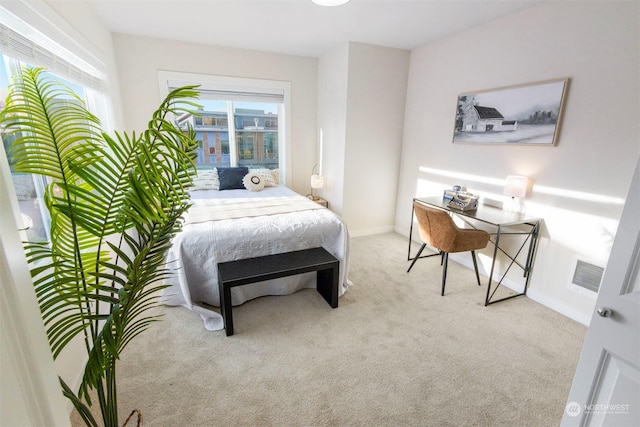 carpeted bedroom featuring multiple windows